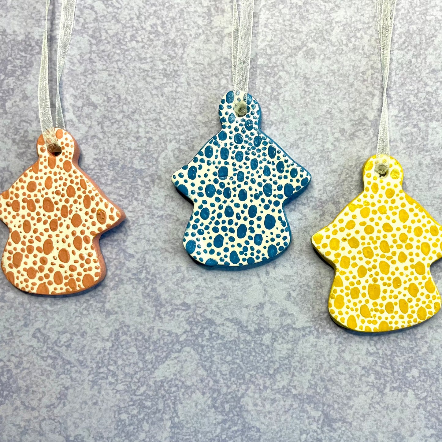 three hanging angel ornaments hand painted spot design , coral , blue and yellow